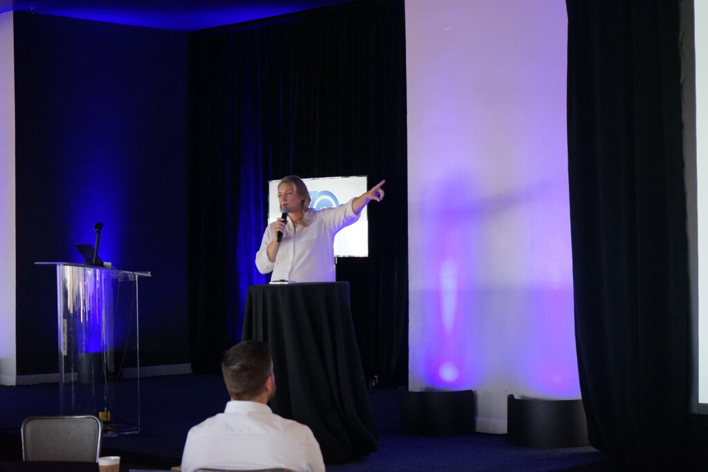 Amber Moser (a Gershman Mortgage loan officer) on stage giving a presentation.