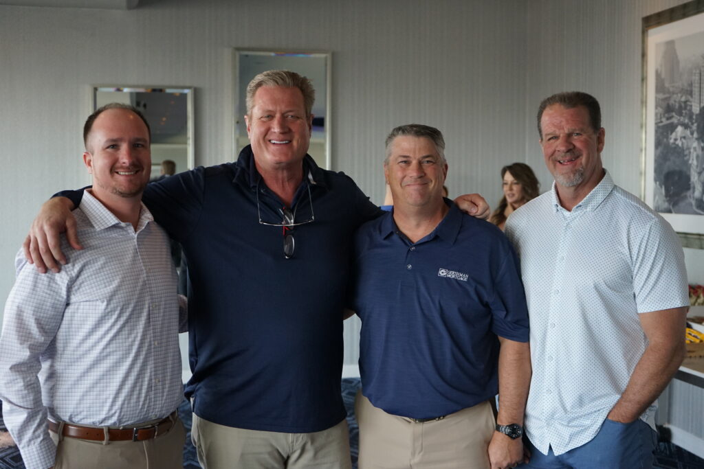 Five Gershman Mortgage employees posing for a picture in a meeting room. 
